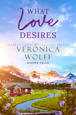 Book cover for What Love Desires by Veronica Wolff, Sierra Falls series, showing a red farmhouse and red pickup truck beside a winding creek below snowcapped mountains, framed by purple flowers.